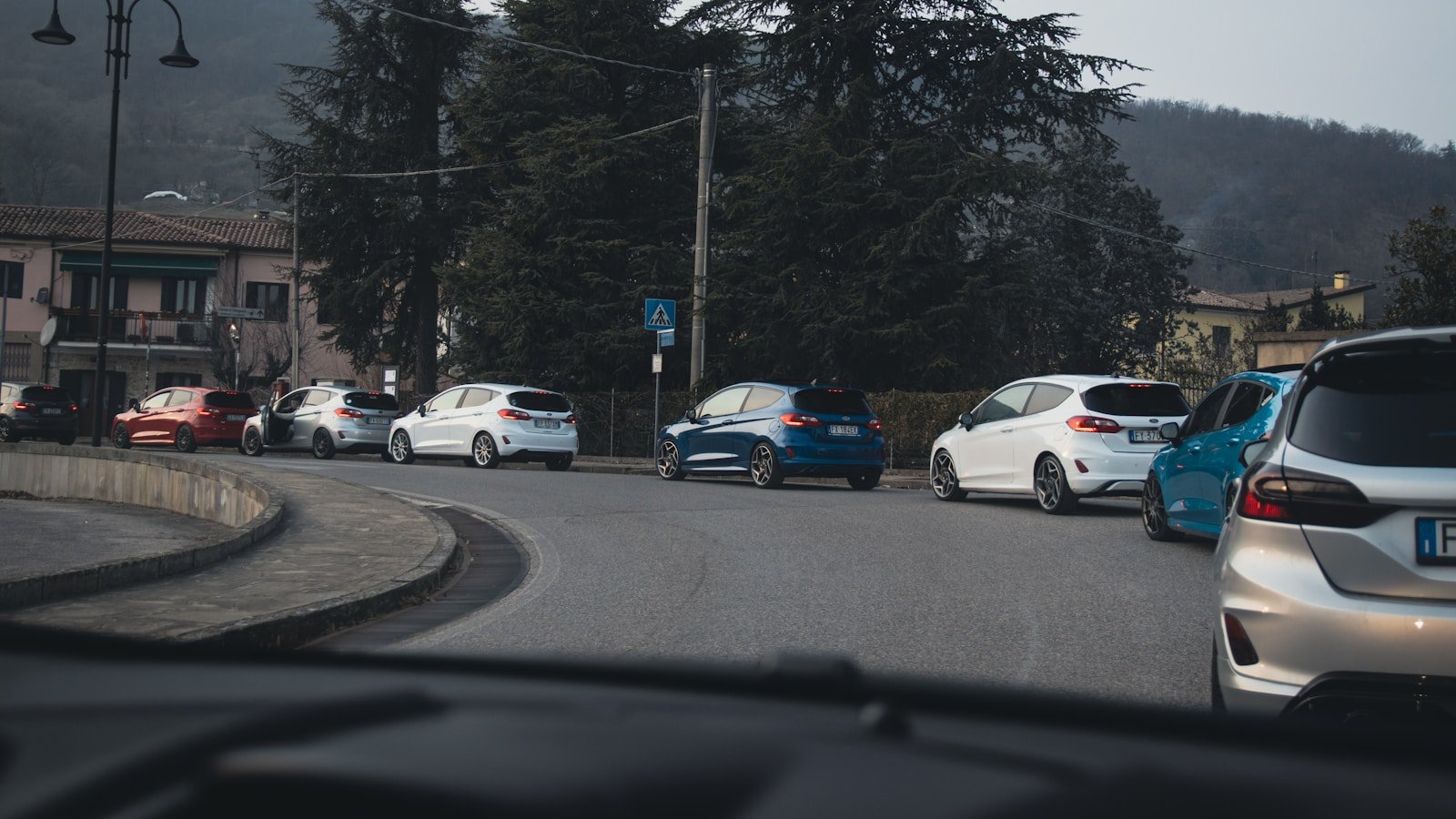 a group of cars parked on the side of a road