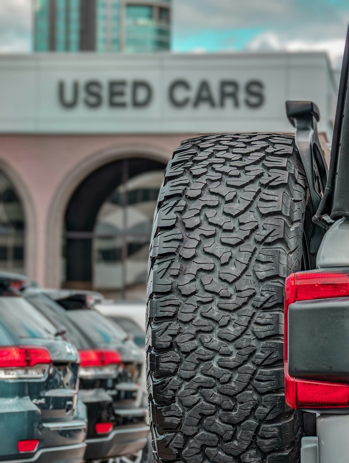 Used cars lined up at a dealership