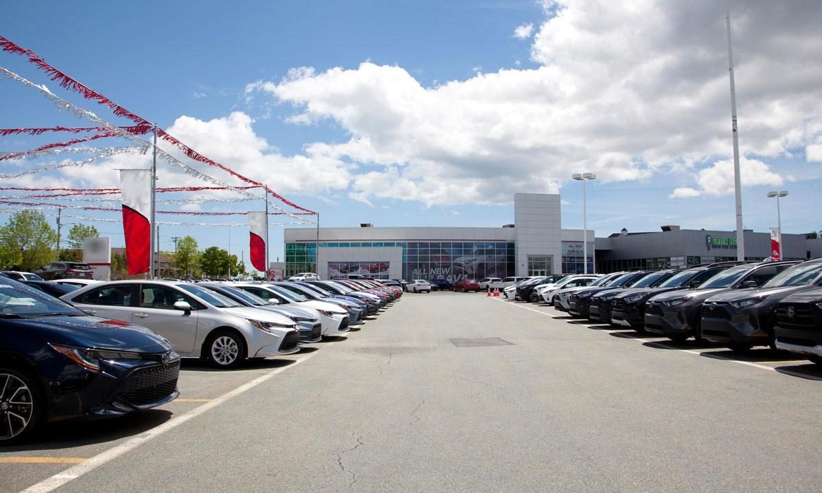 Rows of used vehicles parked at a dealership lot